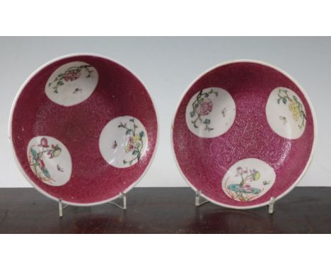 A pair of Chinese ruby ground bowls, Republic period, each painted to circular medallions with insects and flowers on a scrol