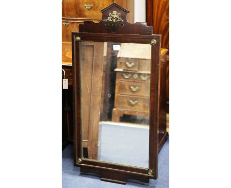 A French Empire style mahogany and brass mounted wall mirror, the architectural pediment with central two handled vase and co