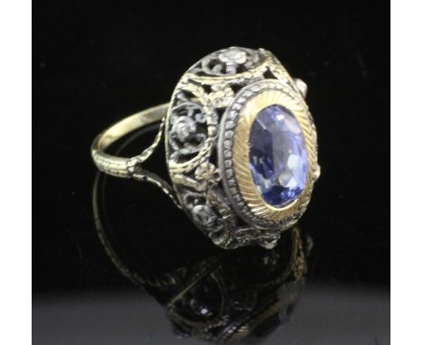 An antique gold and silver, sapphire and rose cut diamond ring, of pierced domed oval form, the blue sapphire weighing 4.16ct