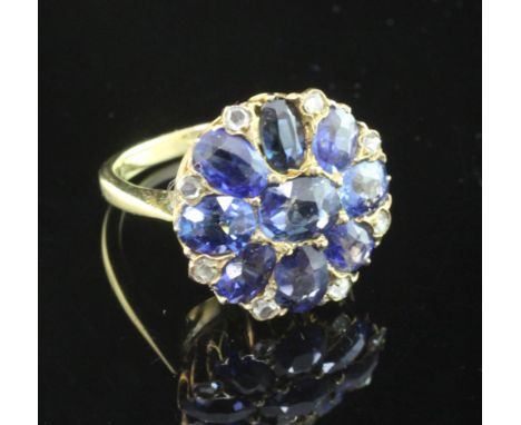 An 18ct gold sapphire and rose cut diamond cluster ring, set with nine shaped cut sapphires, size I.