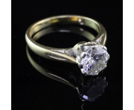 A mid 20th century 18ct gold and platinum solitaire diamond ring, the round brilliant cut stone weighing approximately 0.90-0