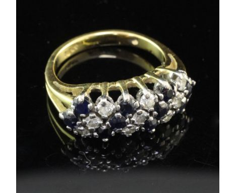 An 18ct gold, sapphire and diamond ring, with diagonal line setting, size L.