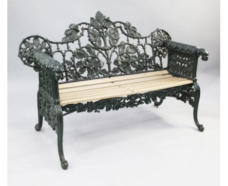 A Victorian cast iron garden bench the pierced back decorated with oak leaves and acorns, and scroll over arms with panther h