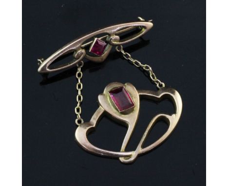 An Edwardian Art Nouveau 9ct gold and synthetic ruby set drop pendant by Barnet Henry Joseph, of stylised scroll form, 1.5in.
