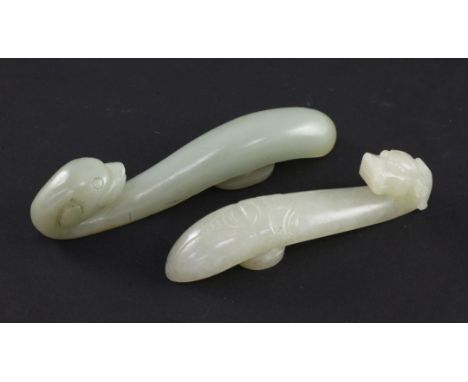 Two Chinese celadon jade belt hooks, 19th century, the first with a dragon head terminal, the other end carved as a cicada, 9