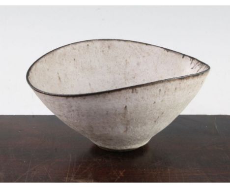 Dame Lucie Rie D.B.E. (1902-1995). A stoneware elliptical bowl, the dark brown stoneware body covered in a thick white glaze 