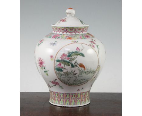 A Chinese famille rose baluster jar and cover, c.1910, finely painted with three medallions of magpies, crane and lotus and p