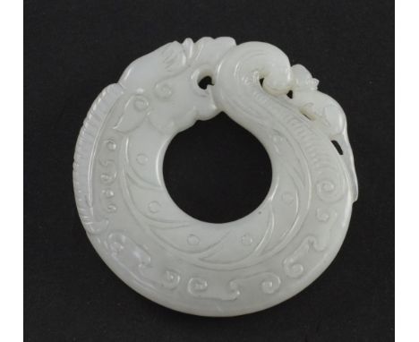 A Chinese archaistic white jade huang disc, carved as a curving chi-dragon and rat, carved in low relief with scrolls, 5.5cm