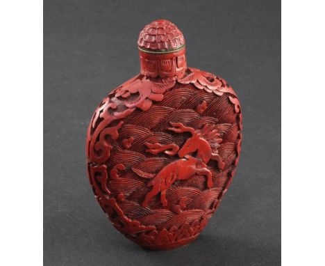 A Chinese cinnabar lacquer flask shaped snuff bottle, 1800-1900, carved in relief to each side with a mythical beast issuing 