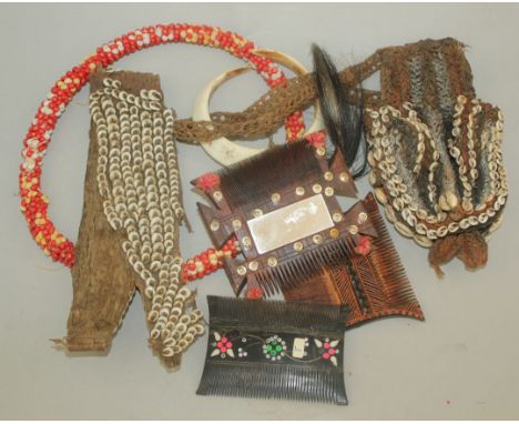A collection of Papua New Guinea beadwork items, together with two combs, a boar's tusk pendant and a bone dagger