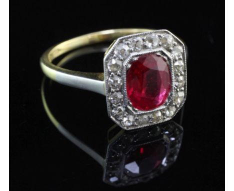 A 1920's/1930's 18ct gold and platinum, synthetic ruby and diamond cluster ring, of octagonal form, the oval cut ruby surroun