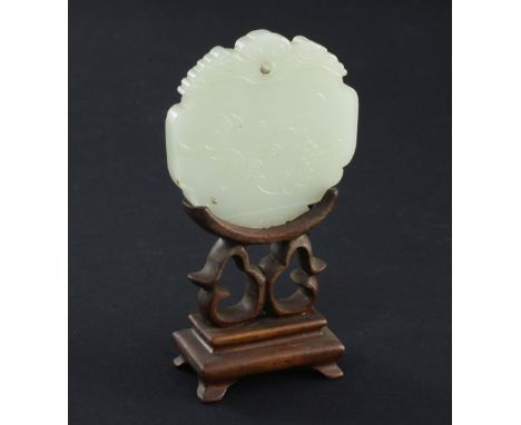 A Chinese pale celadon jade plaque, 19th century, carved in relief with a fruiting vine, the reverse with a seal mark, cloud 