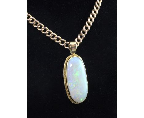 An 18ct gold and white opal oval pendant together with a 15ct gold albert chain, the white opal stone approximately 36mm by 1