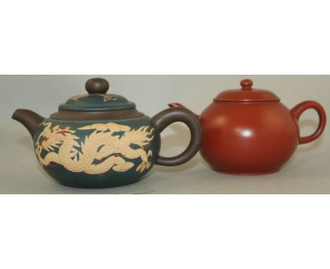 Two Chinese Yixing pottery teapots and covers, 19th and 20th century, the first a 19th century slightly compressed globular t