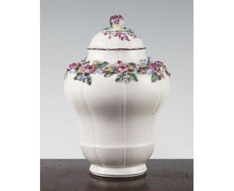 A Mennecy porcelain floral encrusted ogee-shaped vase and cover, c.1760, painted with flowers, 17.5cm