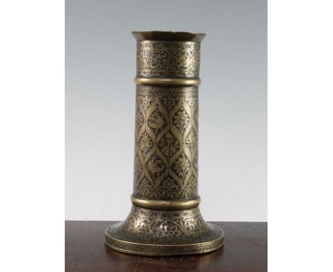 A Persian cast brass torch stand, Qajar dynasty, with a kufic inscription to the neck above repeating lantern shaped reserves