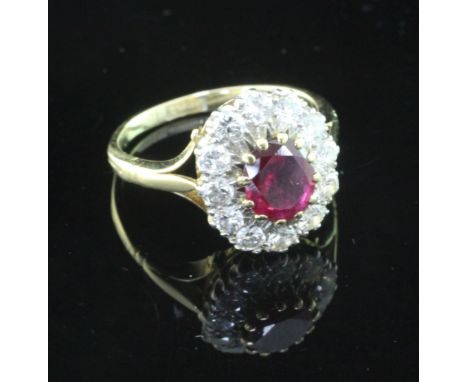 An 18ct gold and platinum, ruby and diamond oval cluster ring, size L.