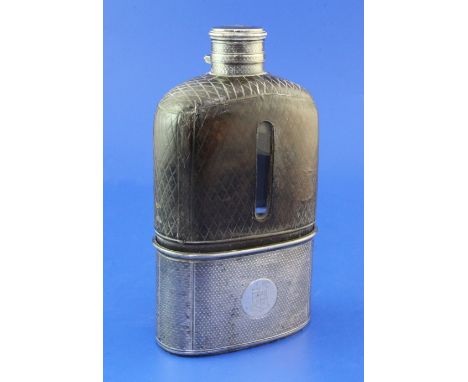 A large Victorian leather and engine turned silver mounted glass hip flask, with engraved armorial and monogram, Thomas Johns