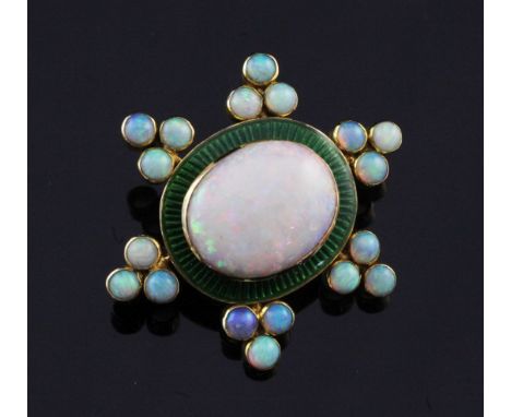 A late Victorian gold, white opal and green enamel brooch, the central oval stone bordered by six triple opal clusters, 1.25i