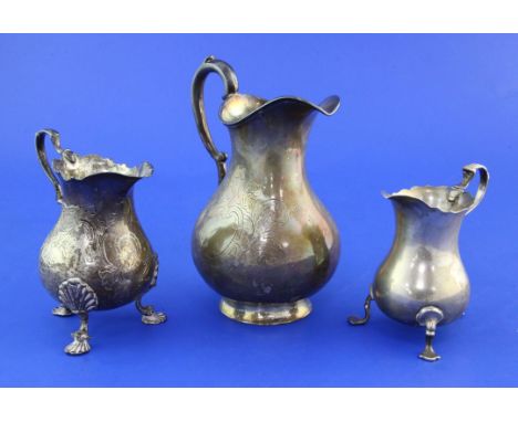 Three Victorian silver baluster cream jugs, two with engraved decoration and two on tripod feet, various makers, largest 5.75