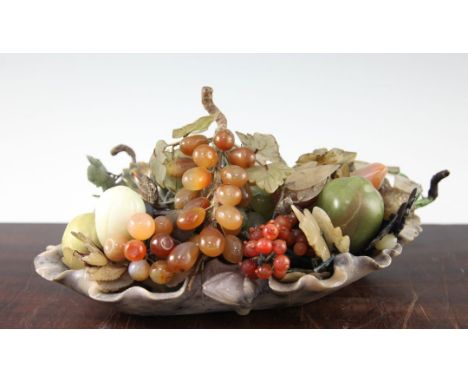 A Chinese soapstone lotus leaf dish, containing hardstone fruits, first half 20th century, the fruits including grapes, prick