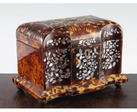 A 19th century tortoiseshell two division tea caddy, the shaped front with floral, leaf and berry mother of pearl inlay, on b