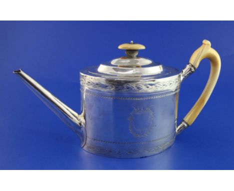 A George III silver teapot, of oval form, with engraved foliate border and ivory handle and finial, Alexander Field, London, 