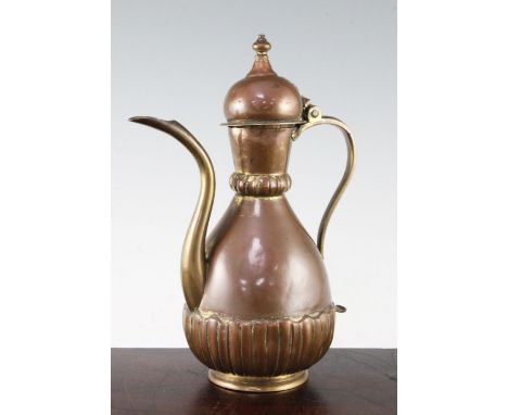 An Ottoman Tombak ewer and cover, Turkey c.1800, with part fluted flared neck and pear shaped body, with S shaped handle and 