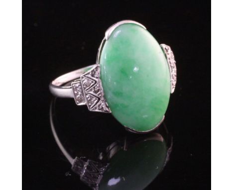 An 18ct white gold, cabochon jadeite oval ring with rose cut diamond set shoulders, size O.