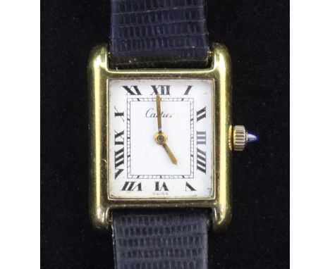 A lady's 18ct gold plated Cartier manual wind wrist watch, with rectangular Roman dial, on associated leather strap.