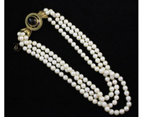 A triple strand cultured pearl choker necklace, with Victorian style gold, cabochon almandine garnet and enamel clasp, 15in.,