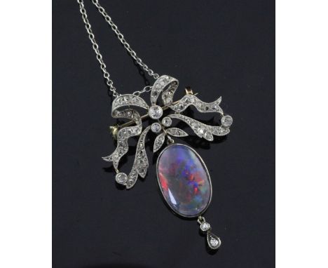 A Belle Epoque style gold, black opal and diamond drop brooch/pendant, now with a white metal chain, with diamond set ribbon 