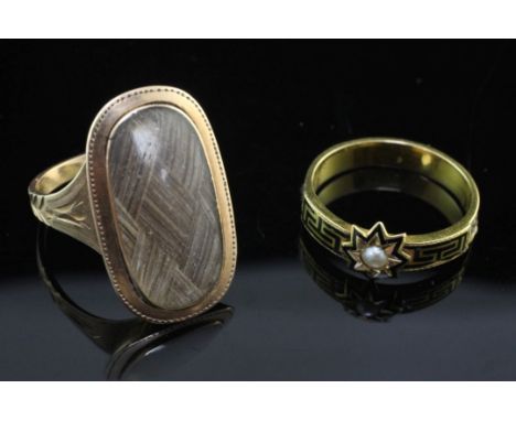 Two Victorian gold mourning rings, one with black enamel and split pearl set star motif, the other with glazed panel with bra