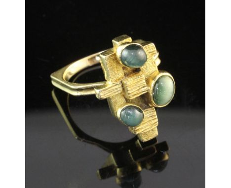 A stylish 1970's? 18ct gold and cat's eye chrysoberyl ring, of stepped free form block design, size O.