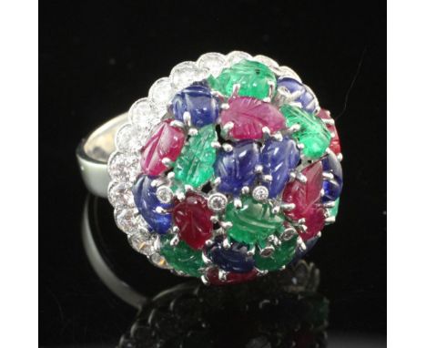 A modern 18ct white gold, diamond and multi gem set dress ring, of domed form, set with carved emeralds, rubies and sapphires