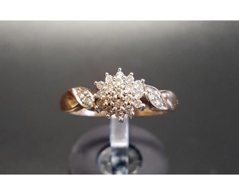 DIAMOND CLUSTER RING
the central diamond cluster flanked by further diamonds to the twist shoulders, on nine carat gold shank