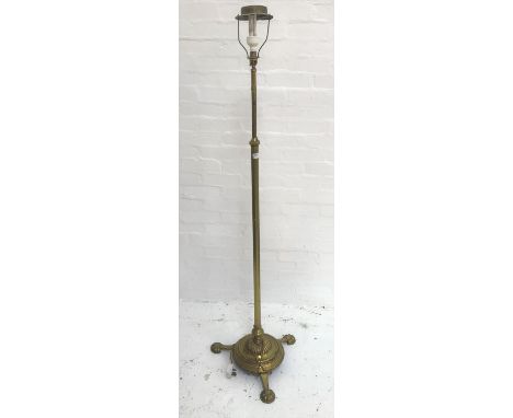 BRASS STANDARD LAMP
raised on a circular base with three outswept supports and a turned column, 165cm high 