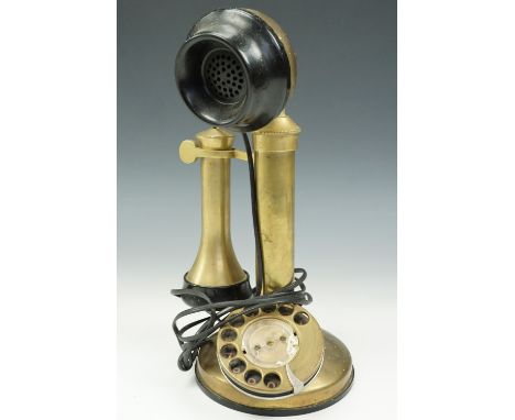 A reproduction rotary dial candlestick telephone