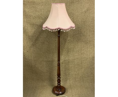 A turned wooden standard lamp