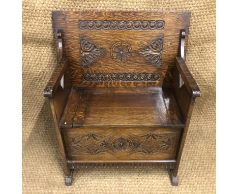 A carved oak monk's bench, circa 1930s, 77 cm x 46 cm x 69 cm