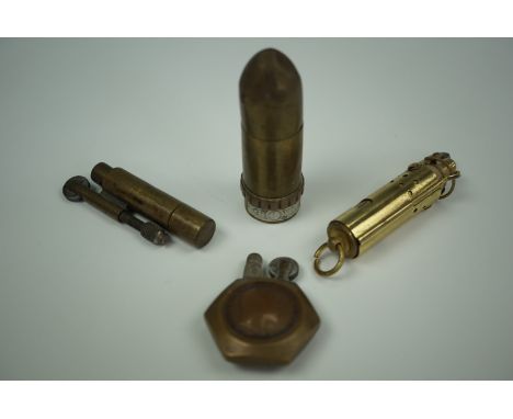 A Great War period French novelty cigarette lighter in the form of an artillery shell, a trench art lighter and two others