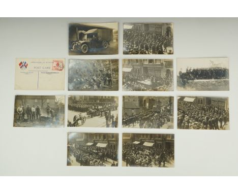 A group of Great War photographic postcards including a portrait of a member of the First Aid Nursing Yeomanry beside an ambu