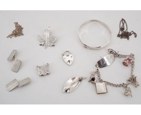 A group of silver and white metal (tested as silver) jewellery including a charm bracelet, bangle, cuff links, padlock clasp 