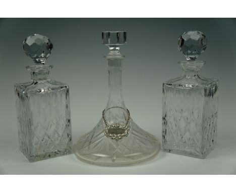 A pair of cut glass spirit decanters together with a cut glass Rodney / ship's decanter and bottle ticket