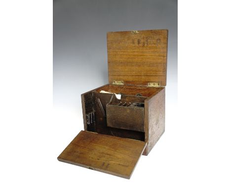 A late 19th / early 20th Century mahogany box containing a number of gun cleaning tools including jags, brushes, oil bottles,