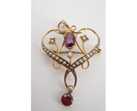A Belle Epoque almandine, graded seed pearl and yellow metal openwork pendant / brooch, stamped 9 ct and tested as gold, 4 cm