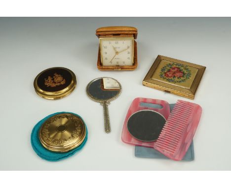 Vintage Gwenda and other powder compacts together with a travel clock, purse mirror and 1960s handbag mirror / comb combinati