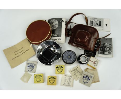 A vintage Agfa 'Ambi Silette' camera together with a matching flash and other accessories 