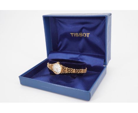 A late 1960s lady's Tissot Stylist 9 ct gold dress watch, having a modernist web-like flexible bracelet strap, boxed, 13.8 g 