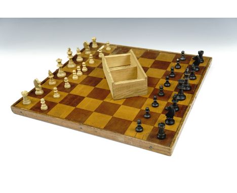 A late 19th / early 20th Century parquetry reversible chess and checkers board together with a boxed wooden chess set, (kings